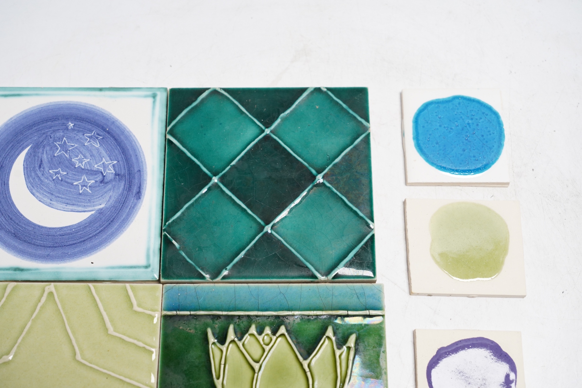 A collection of forty-three Kenneth Clark ceramic tiles and a quantity of related smaller spacer tiles, larger tiles 10x10cm
